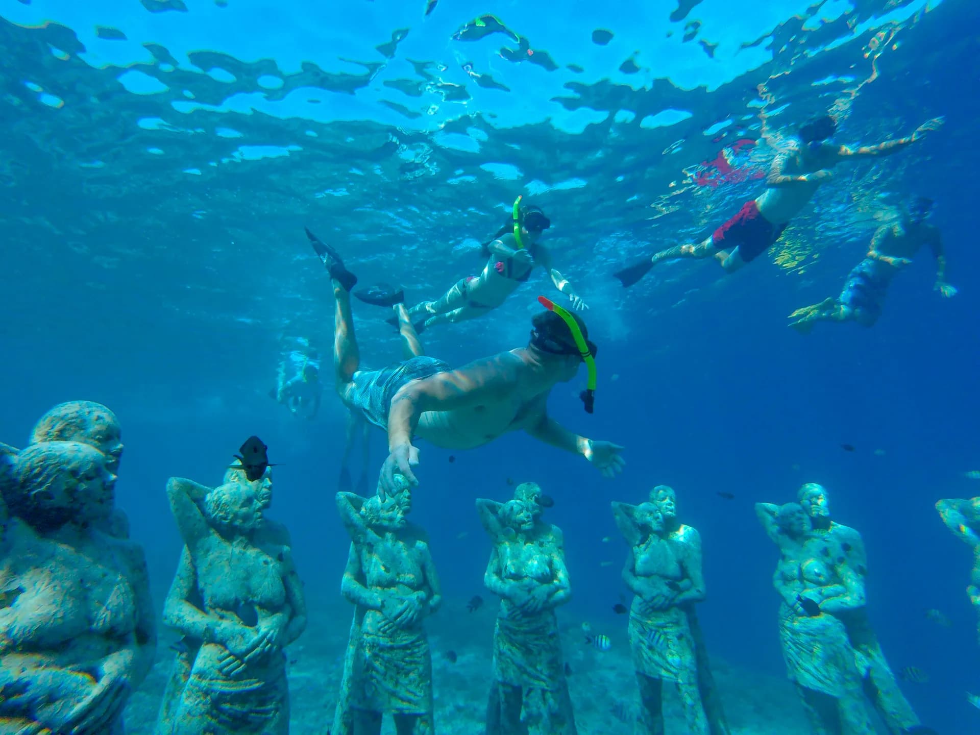 Guests snorkeling over Gili's underwater sculpture park